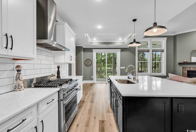 103 Pigeon Forge Ct, Murrells Inlet, SC 29576 - kitchen featuring wall chimney exhaust hood, high end stainless steel range, ornamental molding, light wood finished floors, and backsplash