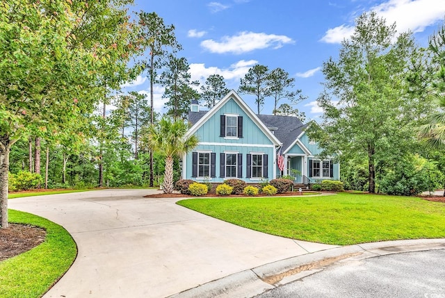 103 Pigeon Forge Ct, Murrells Inlet, SC 29576 - craftsman inspired home with a front lawn, driveway, board and batten siding, and a chimney