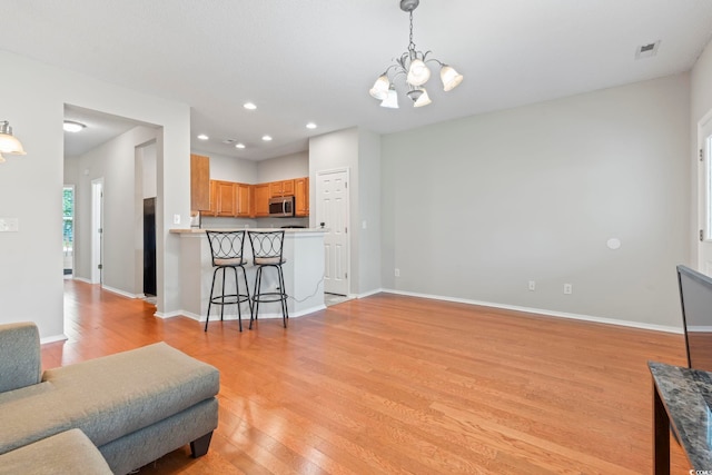 314 Kiskadee Loop Unit 8-C, Conway, SC 29526 - living room featuring a chandelier, light wood finished floors, and recessed lighting