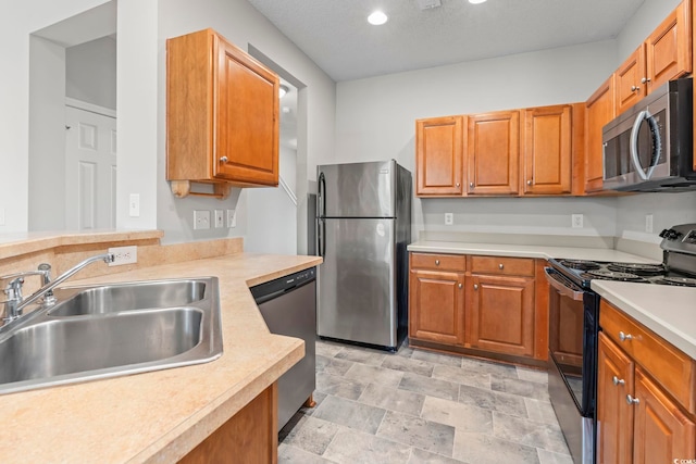 314 Kiskadee Loop Unit 8-C, Conway, SC 29526 - kitchen featuring stainless steel appliances, light countertops, brown cabinets, recessed lighting, and stone finish floors