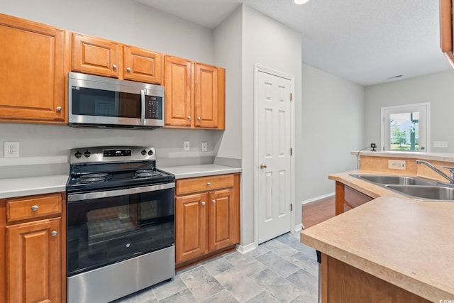 314 Kiskadee Loop Unit 8-C, Conway, SC 29526 - kitchen featuring stainless steel appliances, light countertops, and brown cabinetry