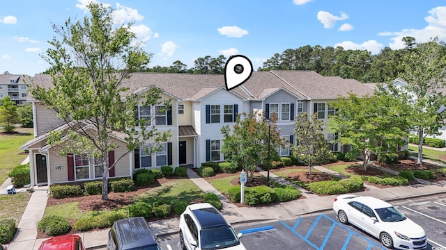 314 Kiskadee Loop Unit 8-C, Conway, SC 29526 - view of front facade with a standing seam roof, uncovered parking, a metal roof, and a shingled roof