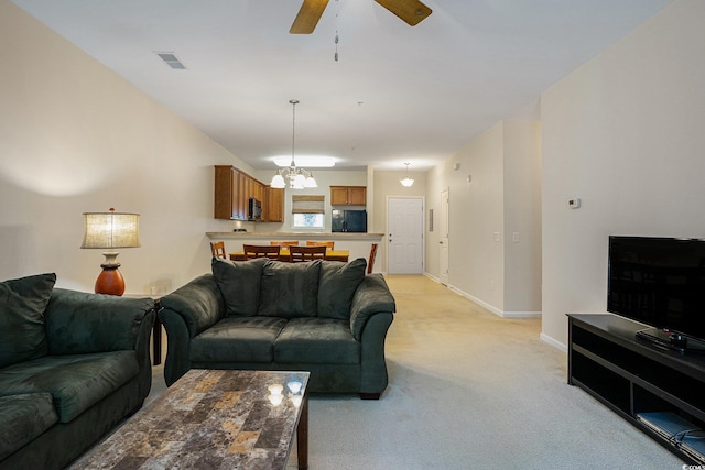 6253 Catalina Dr Unit 1523, North Myrtle Beach, SC 29582 - living room featuring light colored carpet, a chandelier, a ceiling fan, and baseboards