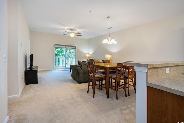 6253 Catalina Dr Unit 1523, North Myrtle Beach, SC 29582 - dining room with light colored carpet, a ceiling fan, a chandelier, and baseboards