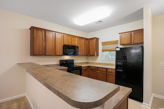 6253 Catalina Dr Unit 1523, North Myrtle Beach, SC 29582 - kitchen featuring black appliances, a peninsula, brown cabinets, and baseboards