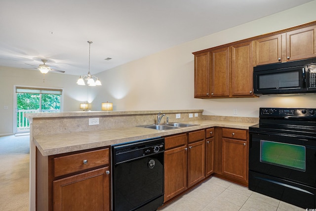 6253 Catalina Dr Unit 1523, North Myrtle Beach, SC 29582 - kitchen featuring black appliances, a peninsula, a sink, light countertops, and brown cabinets