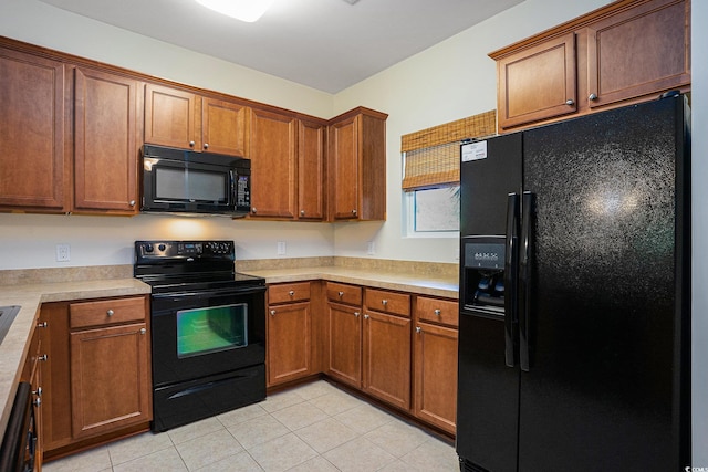 6253 Catalina Dr Unit 1523, North Myrtle Beach, SC 29582 - kitchen with black appliances, light tile patterned flooring, light countertops, and brown cabinets