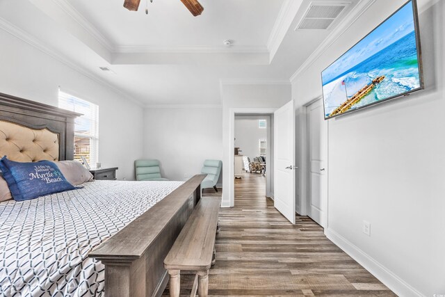 1008 Mary Read Dr, North Myrtle Beach, SC 29582 - bedroom featuring wood finished floors, ornamental molding, a raised ceiling, and ceiling fan