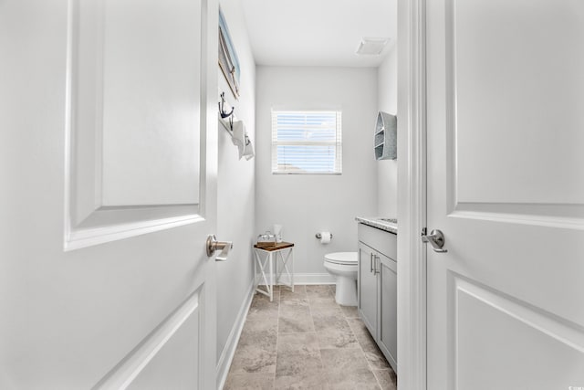 1008 Mary Read Dr, North Myrtle Beach, SC 29582 - bathroom with baseboards, toilet, and vanity