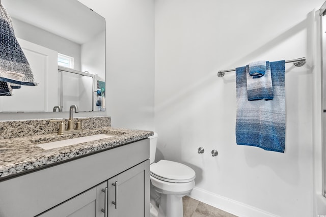 1008 Mary Read Dr, North Myrtle Beach, SC 29582 - full bathroom featuring vanity, toilet, a shower with shower door, tile patterned flooring, and baseboards