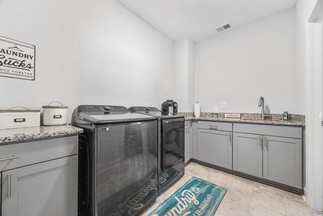 1008 Mary Read Dr, North Myrtle Beach, SC 29582 - laundry area with washer and clothes dryer and cabinet space