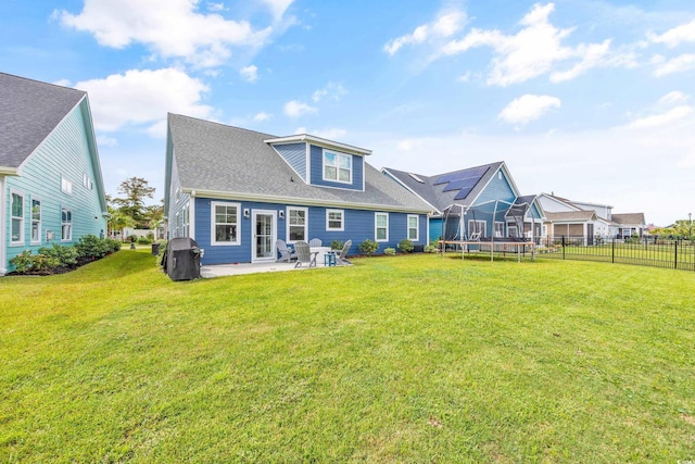 1008 Mary Read Dr, North Myrtle Beach, SC 29582 - back of property with a trampoline, a patio, and a shingled roof
