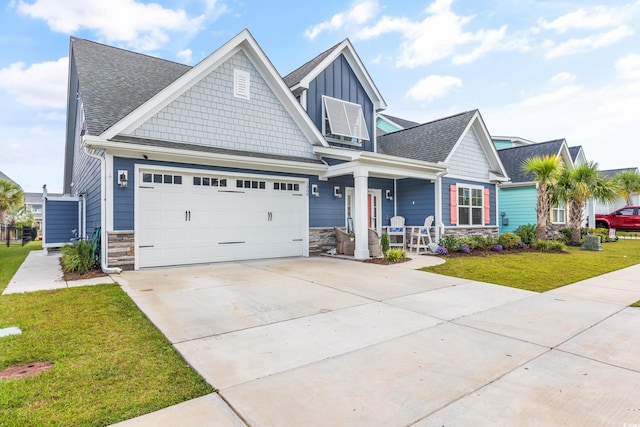 1008 Mary Read Dr, North Myrtle Beach, SC 29582 - craftsman-style home with covered porch, a front lawn, concrete driveway, stone siding, and board and batten siding