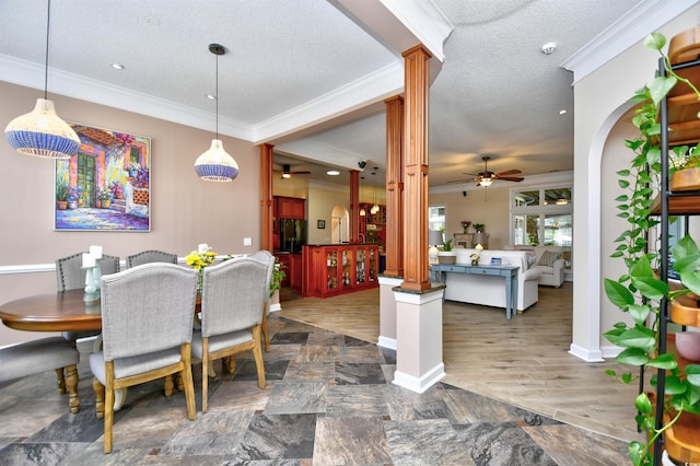 5718 Herring Gull Cir N, Myrtle Beach, SC 29582 - dining area featuring a ceiling fan, decorative columns, crown molding, a textured ceiling, and baseboards