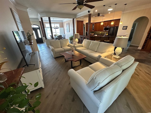 5718 Herring Gull Cir N, Myrtle Beach, SC 29582 - living area featuring arched walkways, crown molding, a ceiling fan, dark wood finished floors, and recessed lighting