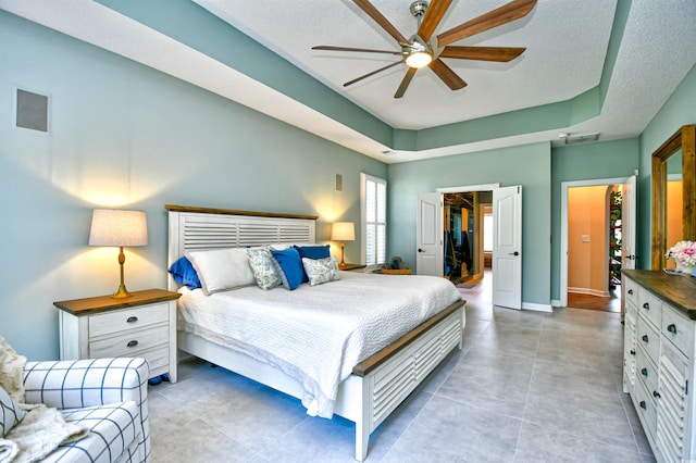 5718 Herring Gull Cir N, Myrtle Beach, SC 29582 - bedroom featuring a tray ceiling, a walk in closet, baseboards, a closet, and a ceiling fan