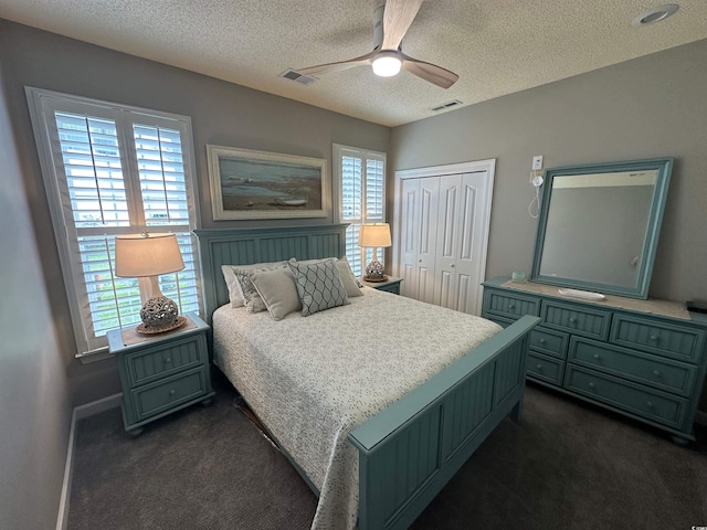 5718 Herring Gull Cir N, Myrtle Beach, SC 29582 - bedroom featuring dark colored carpet, a textured ceiling, a closet, ceiling fan, and baseboards