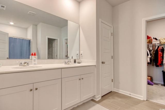 212 Carolina Lakes Blvd, Myrtle Beach, SC 29588 - bathroom featuring double vanity, baseboards, a spacious closet, recessed lighting, and a shower with curtain