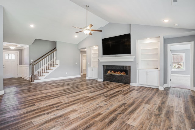 2004 Potomac Ct, Myrtle Beach, SC 29579 - unfurnished living room featuring wood finished floors, ceiling fan, a tiled fireplace, stairway, and built in features