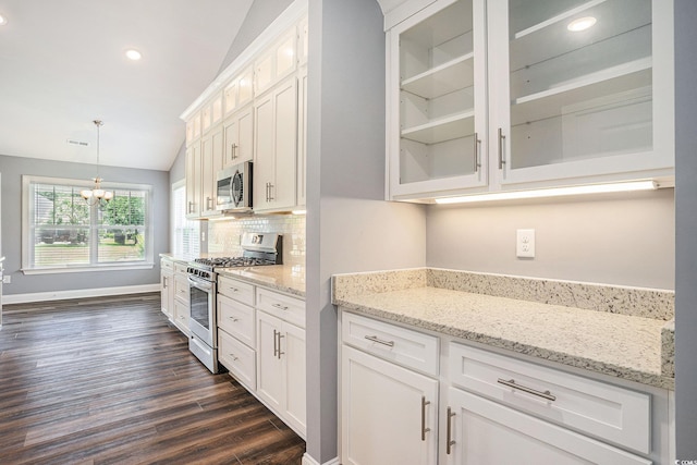 2004 Potomac Ct, Myrtle Beach, SC 29579 - kitchen featuring appliances with stainless steel finishes, dark wood-style floors, white cabinetry, a chandelier, and glass insert cabinets