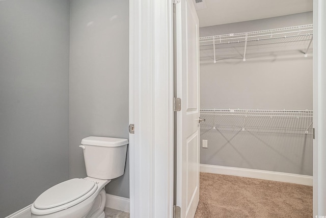 2004 Potomac Ct, Myrtle Beach, SC 29579 - bathroom with a walk in closet, toilet, and baseboards