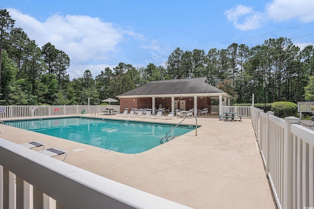 2004 Potomac Ct, Myrtle Beach, SC 29579 - community pool featuring a patio area and view of wooded area