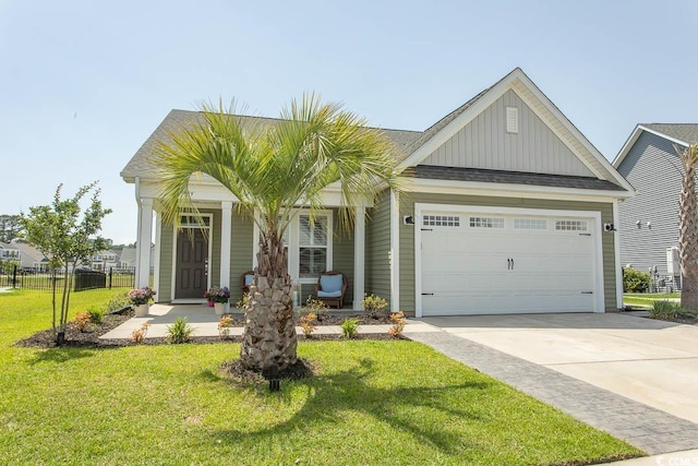 5059 Sundrop Ln, Little River, SC 29566 - view of front of property featuring board and batten siding, a garage, concrete driveway, a porch, and roof with shingles