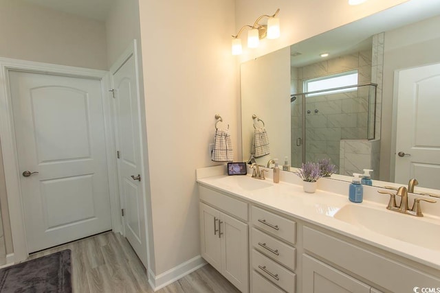 5059 Sundrop Ln, Little River, SC 29566 - bathroom with double vanity, a stall shower, and wood finished floors