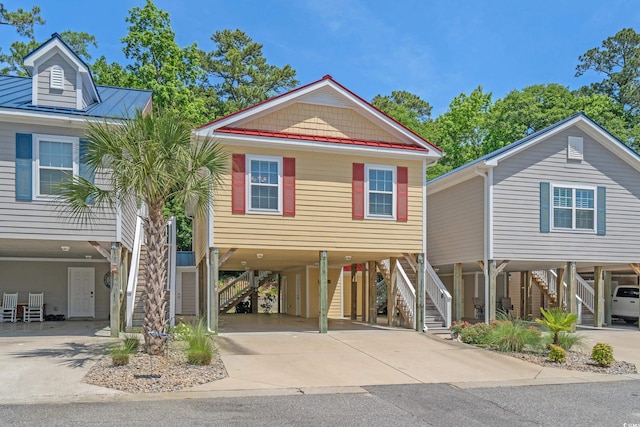 4319 Grande Harbour Blvd, Little River, SC 29566 - coastal home with stairway, a carport, and concrete driveway