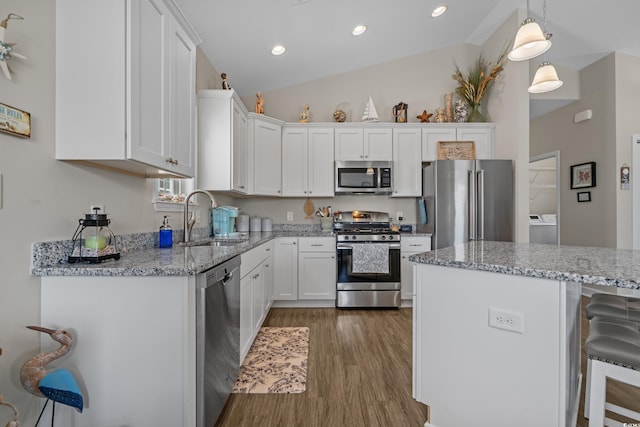 4319 Grande Harbour Blvd, Little River, SC 29566 - kitchen featuring appliances with stainless steel finishes, a sink, wood finished floors, white cabinets, and recessed lighting