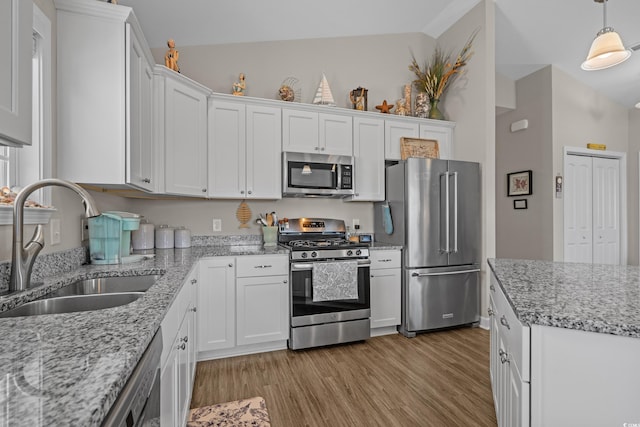 4319 Grande Harbour Blvd, Little River, SC 29566 - kitchen with stainless steel appliances, a sink, white cabinets, light wood-type flooring, and lofted ceiling