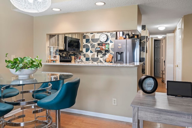 1100 Possum Trot Rd Unit C-203, North Myrtle Beach, SC 29582 - kitchen with stainless steel fridge with ice dispenser, wood finished floors, baseboards, and range with electric cooktop