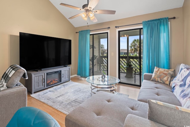 1100 Possum Trot Rd Unit C-203, North Myrtle Beach, SC 29582 - living room with vaulted ceiling, ceiling fan, a glass covered fireplace, and light wood finished floors