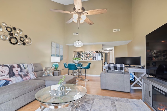 1100 Possum Trot Rd Unit C-203, North Myrtle Beach, SC 29582 - living area with wood finished floors, a towering ceiling, ceiling fan, and baseboards