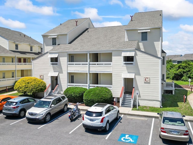 1100 Possum Trot Rd Unit C-203, North Myrtle Beach, SC 29582 - view of property with entry steps and uncovered parking