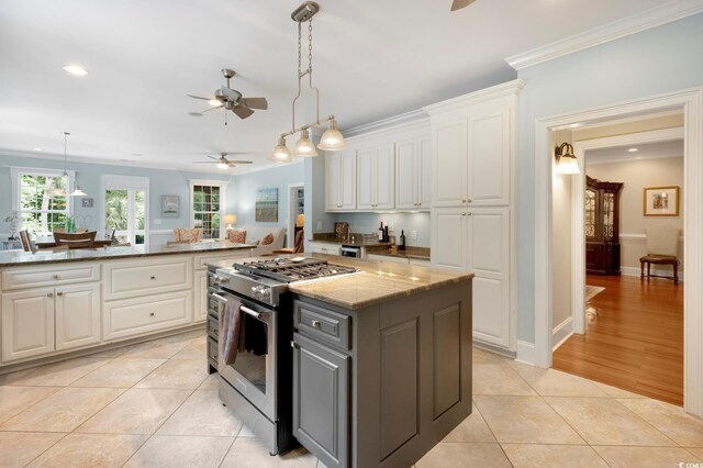 113 Trotter Trl, Georgetown, SC 29440 - kitchen featuring gas stove, ceiling fan, white cabinetry, light tile patterned floors, and ornamental molding