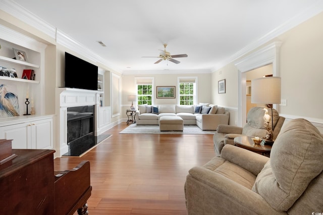 113 Trotter Trl, Georgetown, SC 29440 - living area with a ceiling fan, a premium fireplace, wood finished floors, crown molding, and built in features
