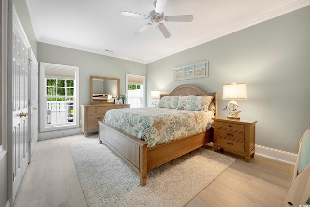 113 Trotter Trl, Georgetown, SC 29440 - bedroom with light wood finished floors, multiple windows, crown molding, a ceiling fan, and baseboards