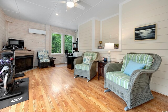 113 Trotter Trl, Georgetown, SC 29440 - sitting room featuring a wall unit AC, wood finished floors, wooden walls, and a ceiling fan