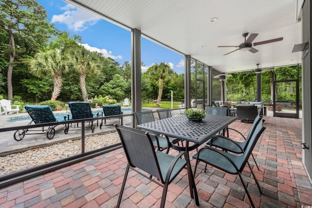 113 Trotter Trl, Georgetown, SC 29440 - view of patio / terrace with outdoor dining area, view of scattered trees, a ceiling fan, and a pool