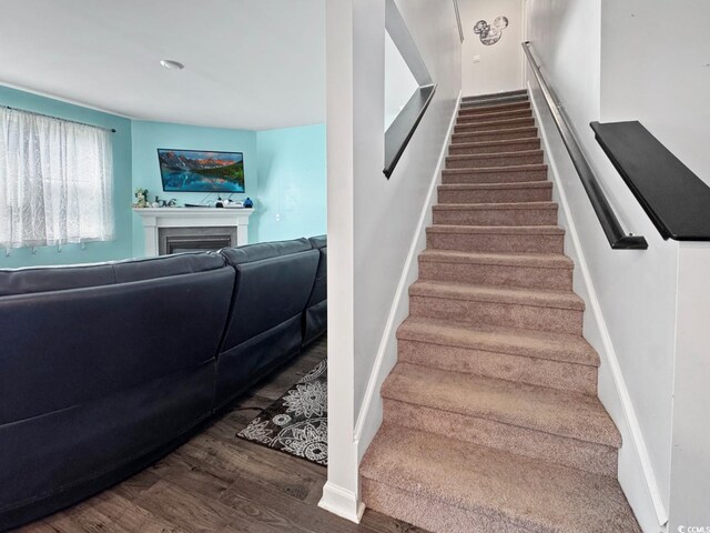 2230 Ainsley Dr, Little River, SC 29566 - staircase with wood finished floors and a fireplace