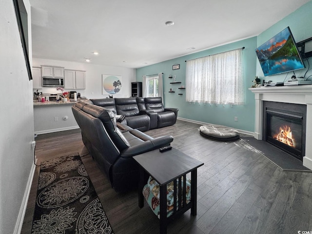 2230 Ainsley Dr, Little River, SC 29566 - living room featuring dark wood-style flooring, a glass covered fireplace, and recessed lighting