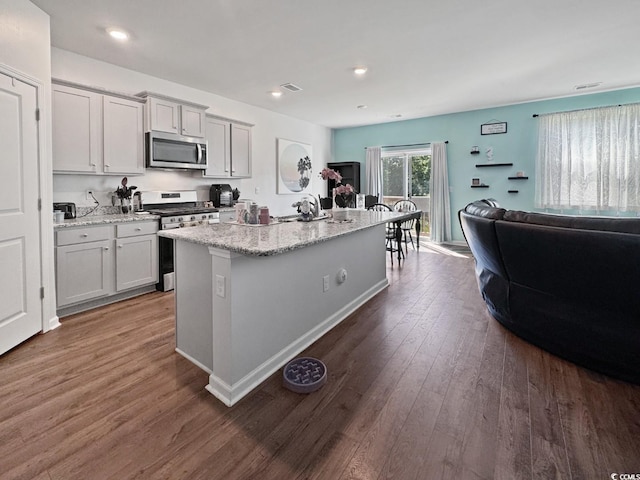 2230 Ainsley Dr, Little River, SC 29566 - kitchen featuring appliances with stainless steel finishes, dark wood finished floors, open floor plan, recessed lighting, and an island with sink