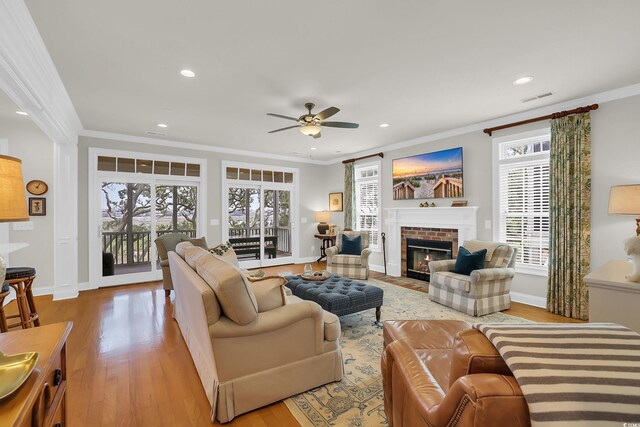 92 High Hammock Way, Pawleys Island, SC 29585 - living area with crown molding, a ceiling fan, wood finished floors, a brick fireplace, and recessed lighting