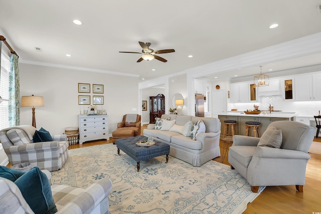 92 High Hammock Way, Pawleys Island, SC 29585 - living room featuring light wood-style floors, recessed lighting, a ceiling fan, and crown molding