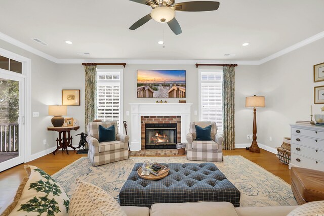 92 High Hammock Way, Pawleys Island, SC 29585 - living area featuring baseboards, crown molding, ceiling fan, wood finished floors, and a fireplace