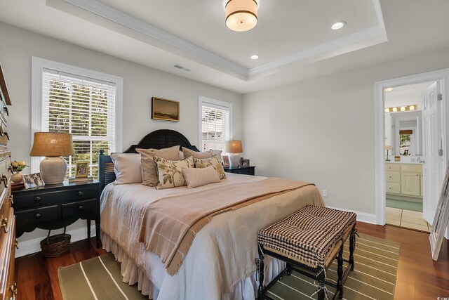 92 High Hammock Way, Pawleys Island, SC 29585 - bedroom with a raised ceiling, wood finished floors, recessed lighting, connected bathroom, and crown molding
