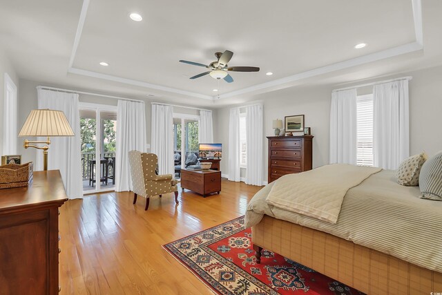 92 High Hammock Way, Pawleys Island, SC 29585 - bedroom featuring a tray ceiling, access to outside, light wood-style flooring, ceiling fan, and recessed lighting