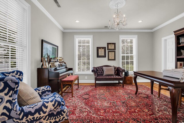 92 High Hammock Way, Pawleys Island, SC 29585 - sitting room featuring wood finished floors, a chandelier, plenty of natural light, ornamental molding, and baseboards