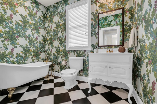 92 High Hammock Way, Pawleys Island, SC 29585 - bathroom featuring a freestanding bath, tile patterned floors, vanity, toilet, and baseboards
